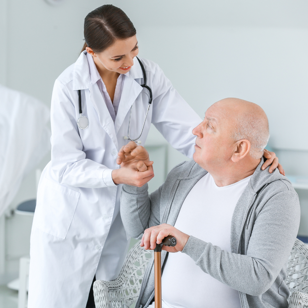 Doctor supporting elderly patient during treatment