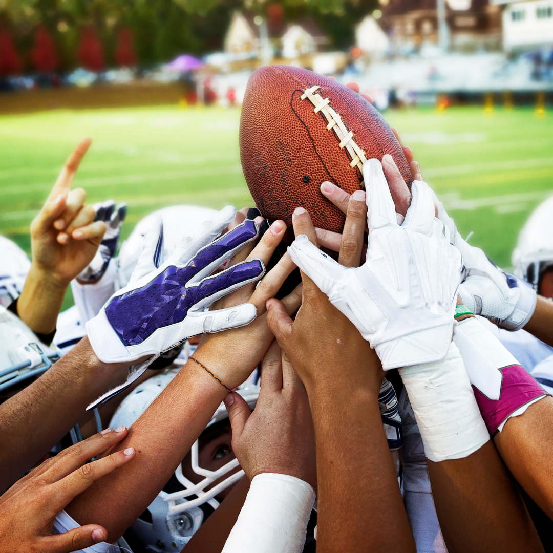 Football team celebrating with ball